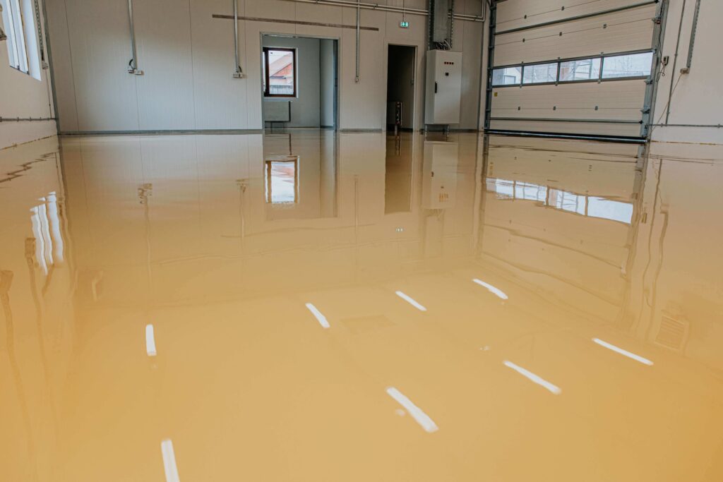 yellow+garage+epoxy Epoxy flooring installation by Ascent Epoxy Miami, showcasing durable and stylish garage solutions for residential spaces.